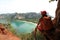 Woman backpacker on mountain rock