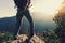 Woman backpacker standing on cliff`s edge