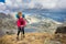 Woman backpacker standing mountain.