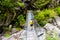 Woman backpacker on trekking path crossing a suspended bridge in Annapurna Conservation Area, Nepal