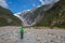 Woman Backpacker walking in Franz Josef Glacier