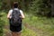 Woman Backpacks Through Grassy Field in Grand Teton