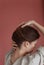 Woman backside closeup straightens hairstyle her hand