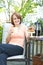 Woman in backyard with coffee and cookies