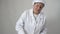 Woman baker in uniform whips flour with egg whites for baking.