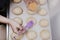 Woman in bakery preparing sweets adding sugar