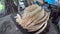 Woman bakes bread in a Georgian clay thorne oven, preparing national baked goods in Georgia, concept of traditional Georgian