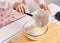 Woman baking healthy muffin with flour mixed ground flaxseed