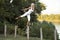 Woman balancing on fence post