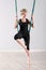 Woman balancing herself with aerial yoga blanket