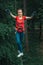 Woman balancing on high in forest adventure rope park