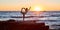 Woman balancing on one leg. Cute sunset view. Ocean landscape and stretch time. Yoga meditation concept, copy space