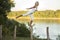 Woman balancing beside river