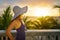 Woman on a balcony looking at the beautiful Caribbean sunset