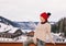 Woman on balcony overlooking mountains looking into the distance