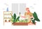 Woman on a balcony or patio growing plants or vegetables in a flowerpot, planting and watering seeds. Concept of urban home