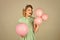 Woman with balloons. Young woman wearing green old-fashion clothes in pinup style