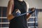 Woman bandage her hands before box sparring on a ring in gym. Cl