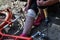 A woman bandaging her injured leg after falling from a bicycle