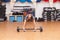 Woman and barbell workout in a gym