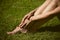 Woman barefoot legs on grass