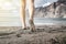 Woman barefoot walking on a beach, summer inspiration