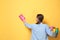 Woman with basin of detergents cleaning wall