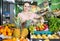 woman with basket with fresh greengrocery enjoying purchases in vegetable store
