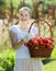 Woman with basket of harvested tomato