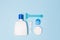 Woman Bath cleaning care morning routine top view flat lay composition with white and blue items on light blue desk