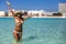 Woman bathing happily on blue seagull beach in Cancun in Riviera Mayan Mexico. Turquoise caribbean beach.