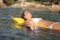 Woman bathing on an inflatable bed on the beach