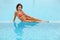 Woman in bathing suit sitting in pool