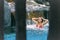 Woman bathing under a waterfall in a private pool