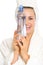 Woman in bathrobe hiding behind bottle with water