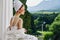 Woman in a bathrobe in a white robe the balcony overlooks the mountains looking on the view