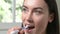 Woman In Bathroom Brushing Teeth With Manual Toothbrush