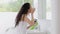 Woman, bathroom and mirror with cream, skincare and start morning routine for beauty, self care or wellness in home