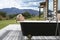 Woman In Bathtub On Porch Against Mountains