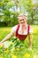 Woman in Bavarian clothes or dirndl on a meadow