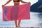 Woman on beach covering hips with towel
