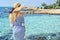 Woman at the beach in Cyprus. Beautiful Summer seaside view. Enjoying sunny days