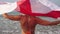 Woman on the beach with english flag. Girl with England flag on the sea in a bikini.