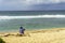 Woman on beach enjoying the view of the seascape