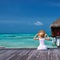 Woman on a beach jetty at Maldives