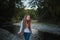 Woman at the Beach by the Lake in Fall Clothing. Young woman spending time by the lake in autumn