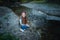 Woman at the Beach by the Lake in Fall Clothing. Young woman spending time by the lake in autumn