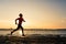 Woman beach running silhouette sunrise, lake coastline