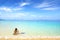 Woman on beach with snorkeling mask and fins.