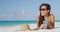 Woman on beach travel vacation smiling and laughing wearing sunglasses